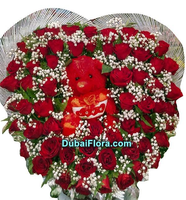 beautifull heart shape  arrangment flowers with a toy